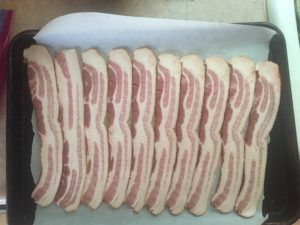 Bacon on parchment paper for Candied Bacon